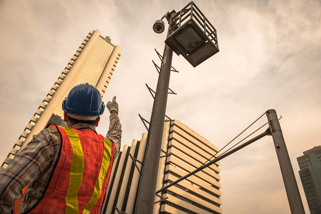 Time lapse camera overlooking construction worker and buildings