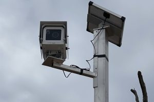 Time lapse camera mounted on pole under cloudy sky for monitoring