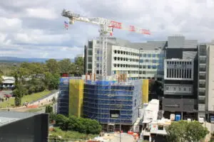 Timelapse camera mounted on pole at construction site with cranes